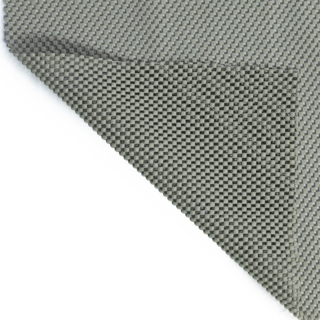 Non-slip rug pad, textured for grip on various floors, slim and neutral-colored for discreet use under rugs.